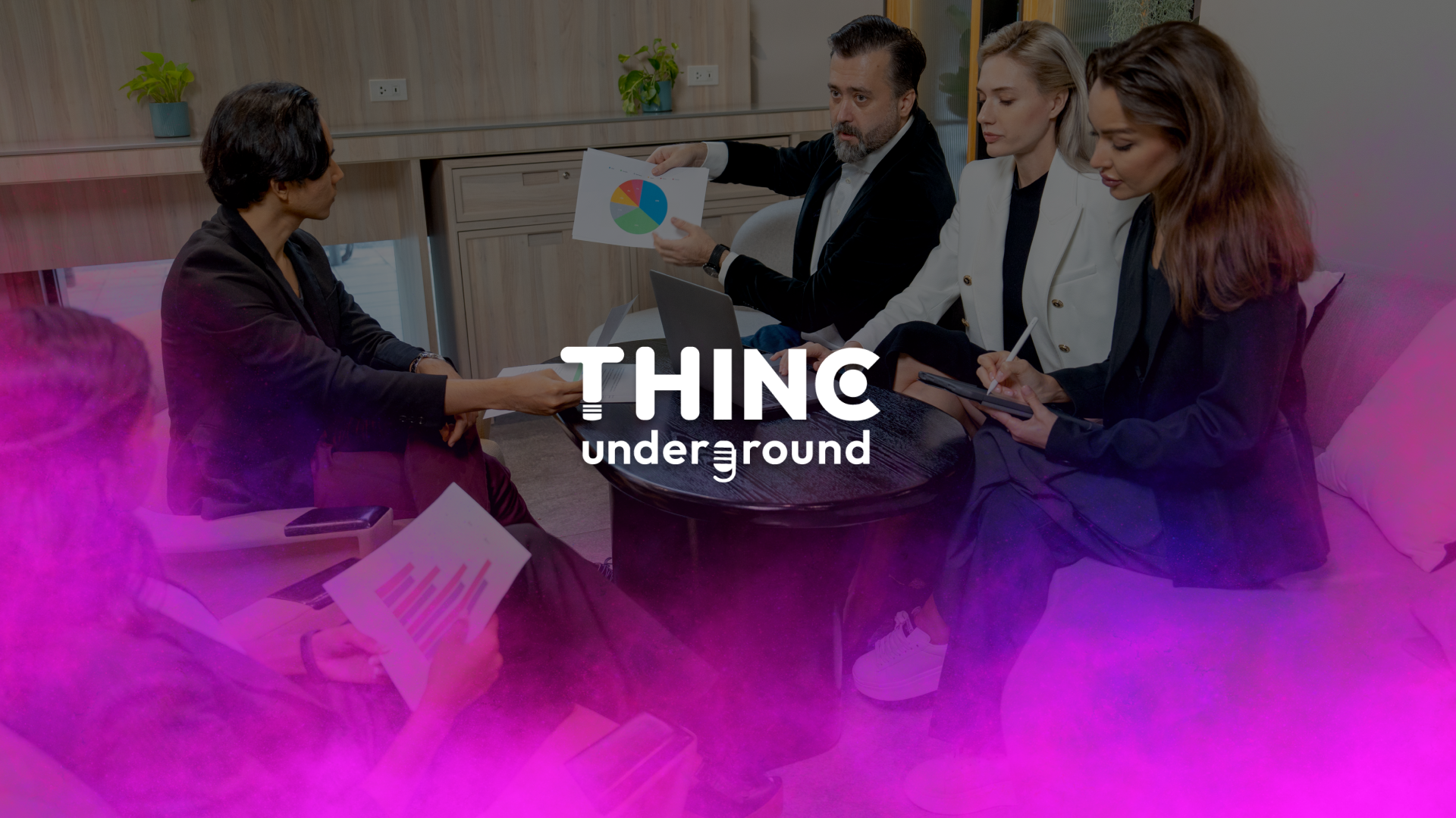 Group of professionals sitting around a table with a chart